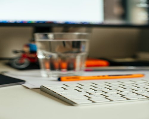 Glass of water on a desk representing hydration